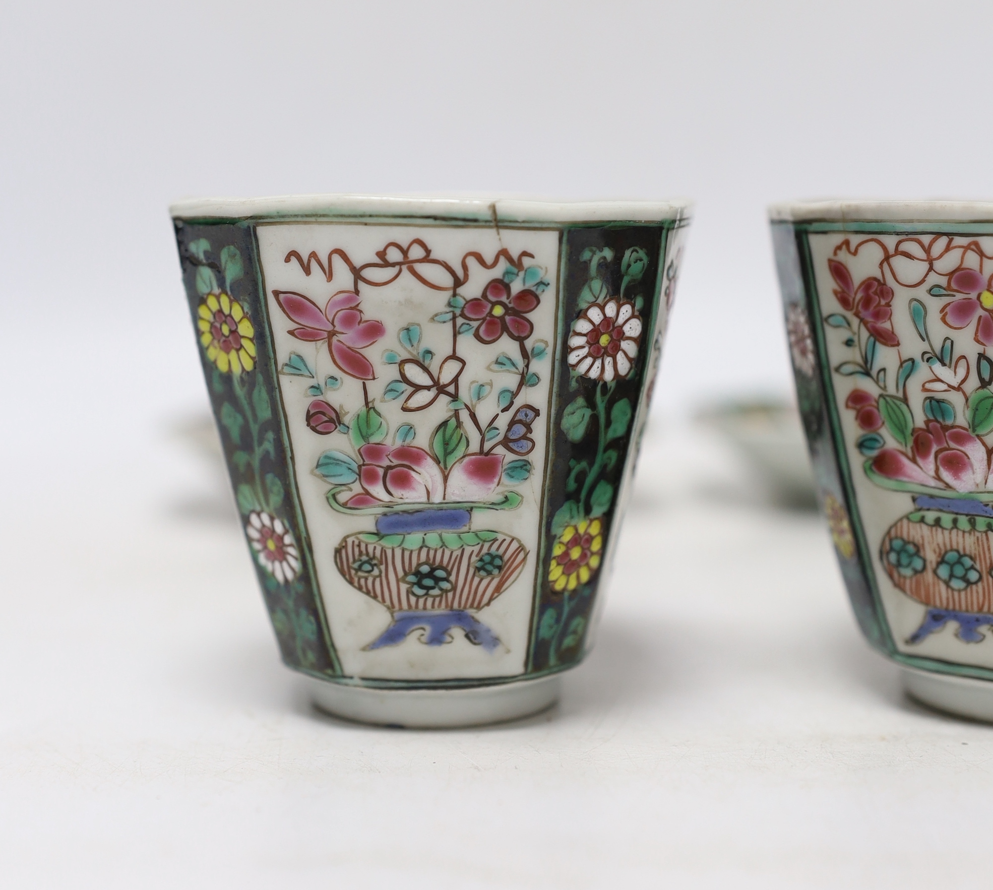 A pair of Chinese Qianlong famille rose octagonal cups and saucers, with panelled floral decoration, saucers 12cm cups height 6.5cm diameter 6.75cm